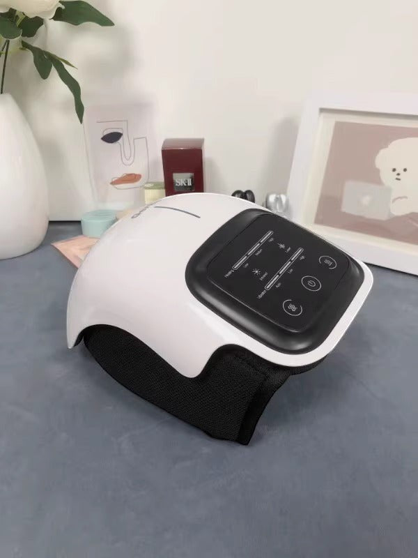 Kneepeak white smart knee massager with black wrap, featuring heat and vibration therapy for pain relief and mobility.