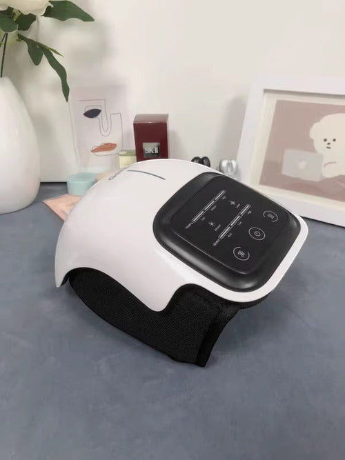 Kneepeak white smart knee massager with black wrap, featuring heat and vibration therapy for pain relief and mobility.